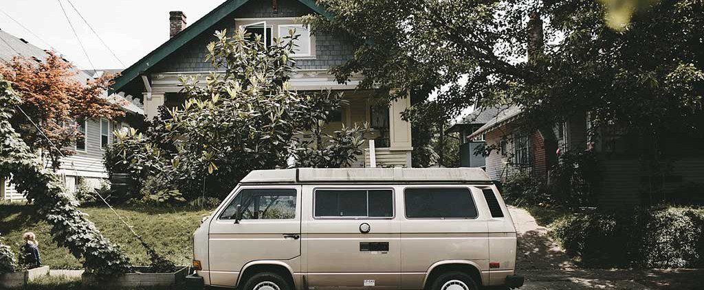 Van parked on the street in front of a home