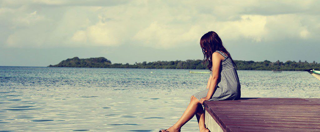 Girl alone on a dock