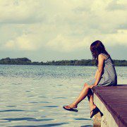 Girl alone on a dock