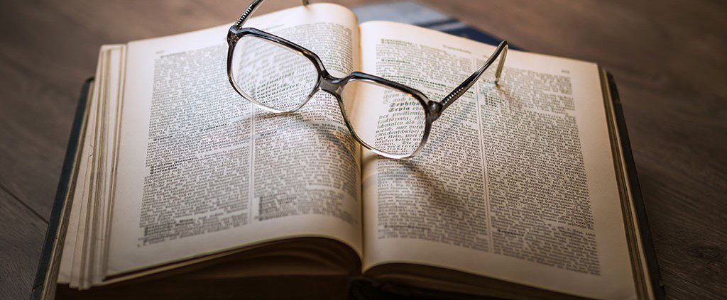 Reading glasses laying on top of a book