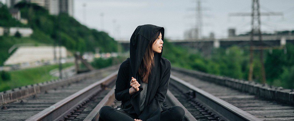 Girl sitting on train tracks - there's more to life than finding your soulmate