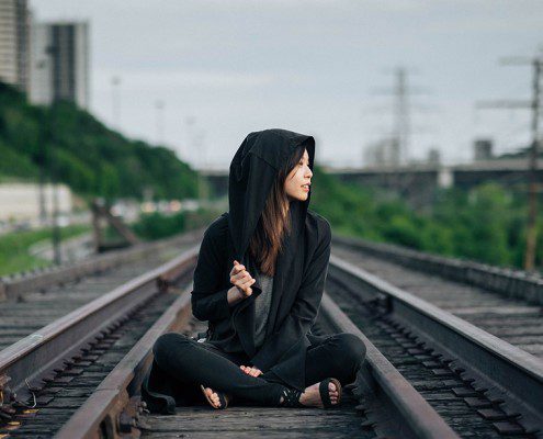 Girl sitting on train tracks - there's more to life than finding your soulmate