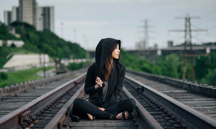 Girl sitting on train tracks - there's more to life than finding your soulmate