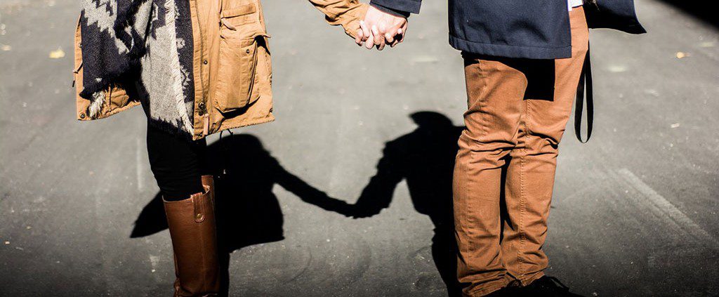 Couple holding hands in the street