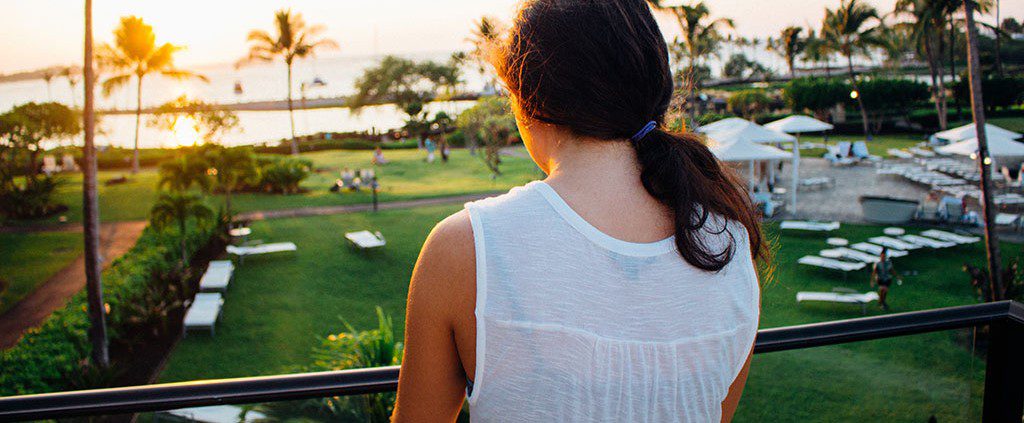 Girl on vacation looking about on her balcony