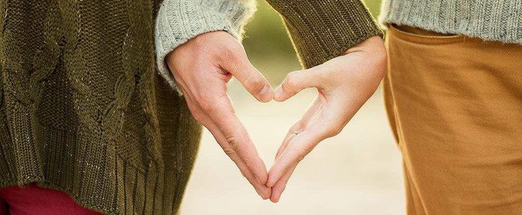 Couple holding hands in the shape of a heart