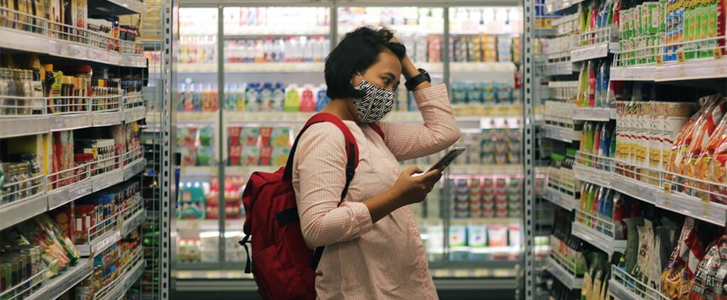 Woman stopped in her tracks in an aisle of the grocery store