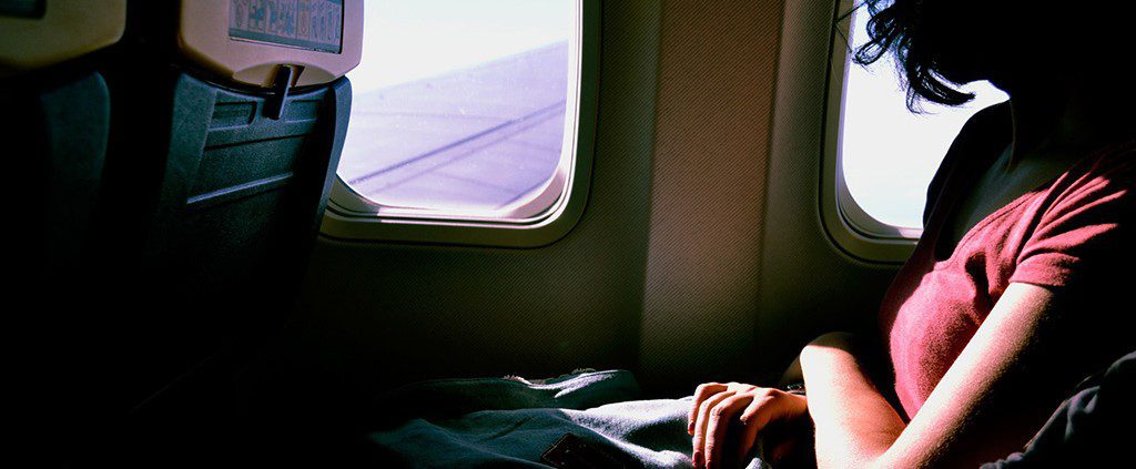 Female looking out of the window on an airplane