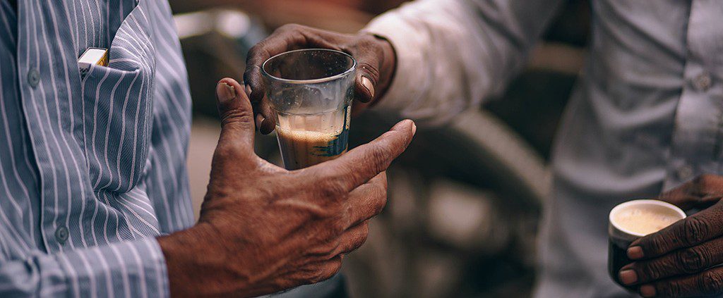 Two men exchanging coffee - giving more than you recieve