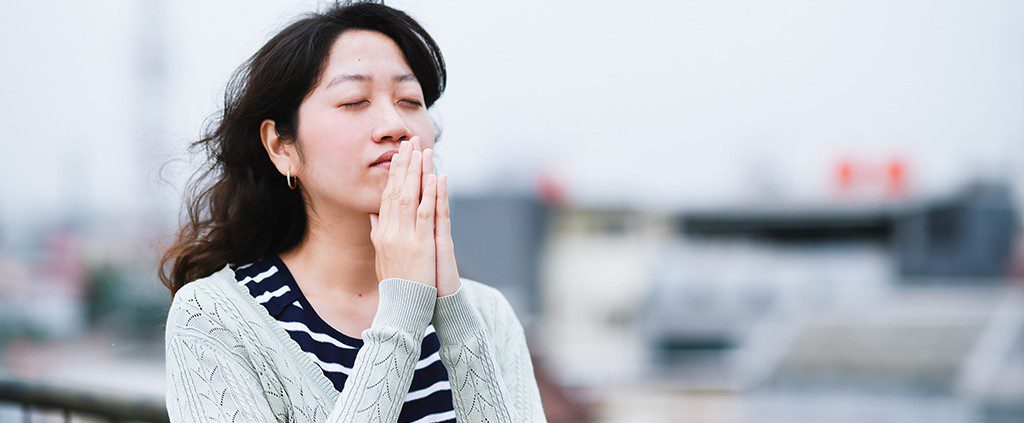 Woman standing alone praying