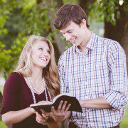 Couple smiling reading the bible together