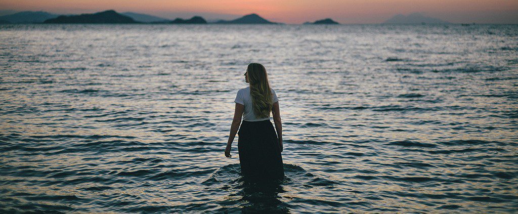 Girl in a lake fully clothed