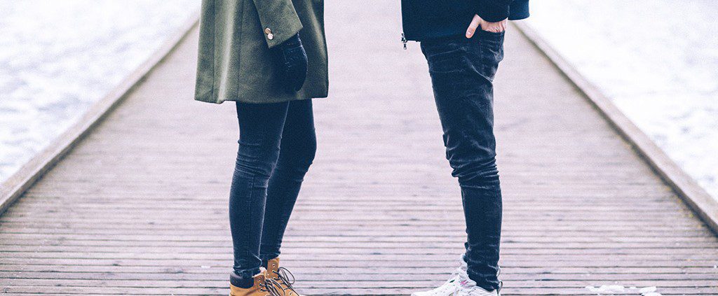 Couple standing together on a bridge