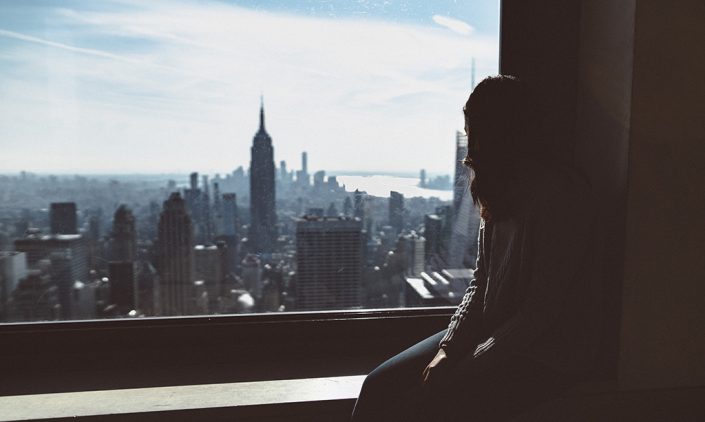 Woman looking out over the New York skyline
