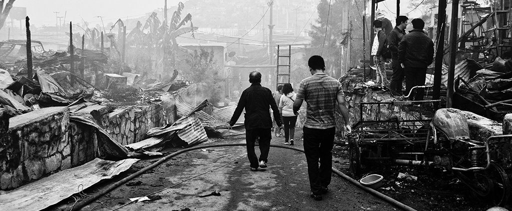 Villagers taking in the damage from a natural disaster