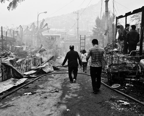 Villagers taking in the damage from a natural disaster