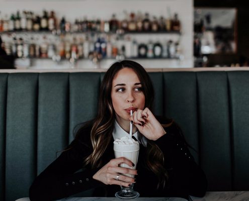Girl sitting drinking a milkshake