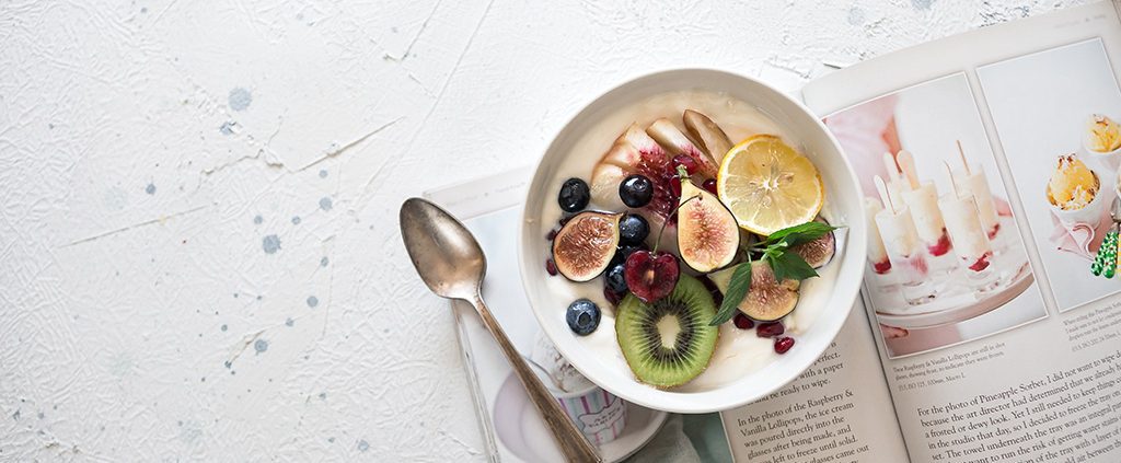 vegan fruit bowl on top of a magazine