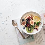 vegan fruit bowl on top of a magazine