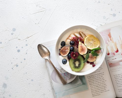 vegan fruit bowl on top of a magazine