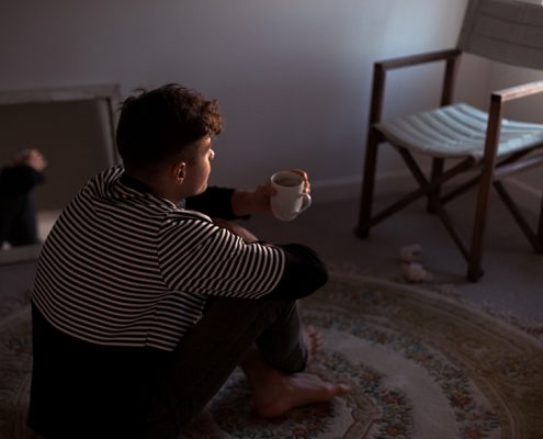 Man sitting on the ground sipping coffee