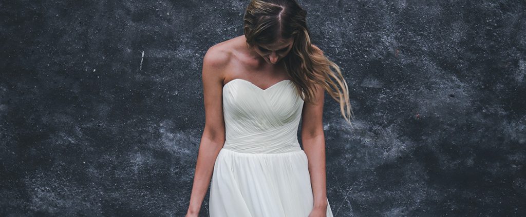 Woman looking down and sad in a wedding dress