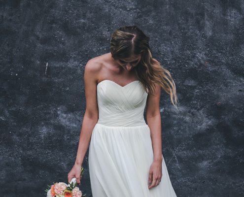 Woman looking down and sad in a wedding dress