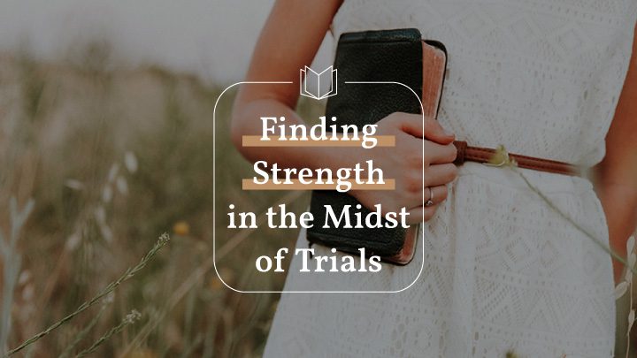 Woman holding bible in a field with text overlay of Finding Strength in the Midst of Trials, a Philippians bible reading plan