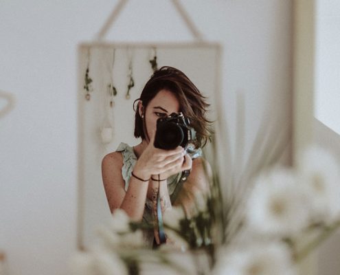 Woman taking a picture in the mirror