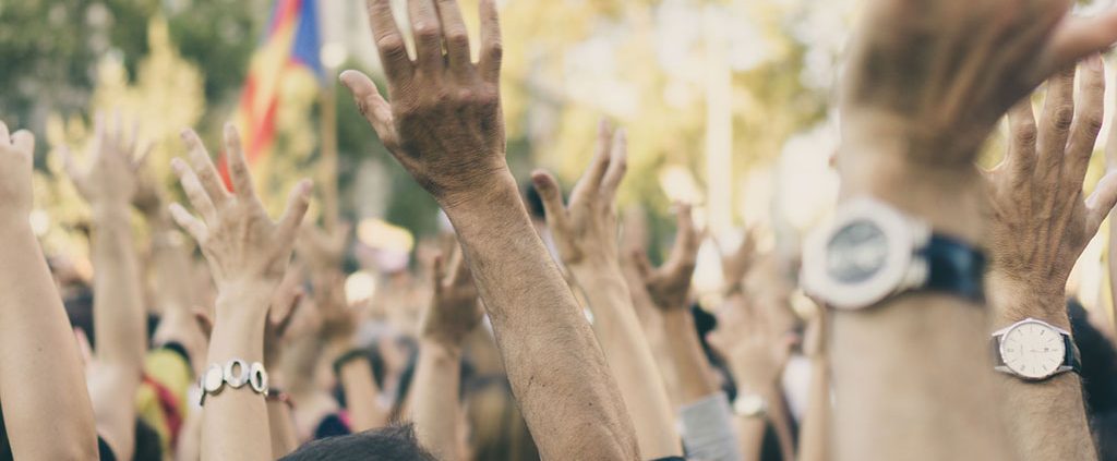 Group of people with their hands raised in the air