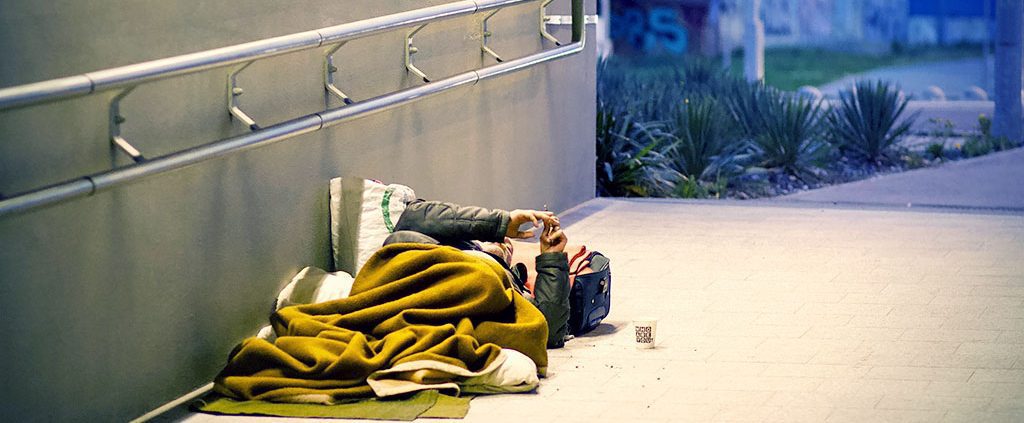 Homeless person laying on the ground