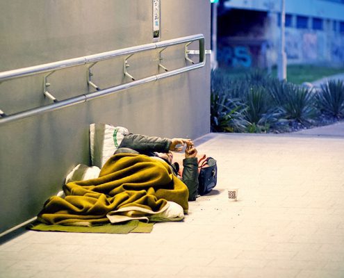 Homeless person laying on the ground
