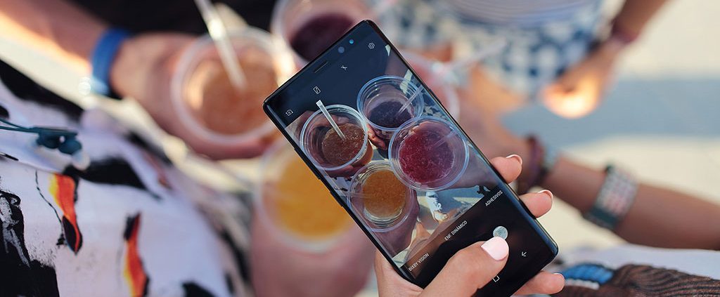 Person taking a picture of their friends drinks