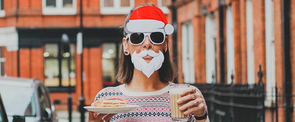 Woman wearing Santa hat and beard sunglasses