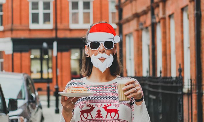 Woman wearing Santa hat and beard sunglasses