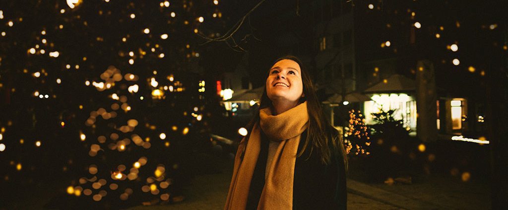 Woman admiring a Christmas tree