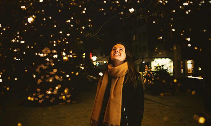 Woman admiring a Christmas tree