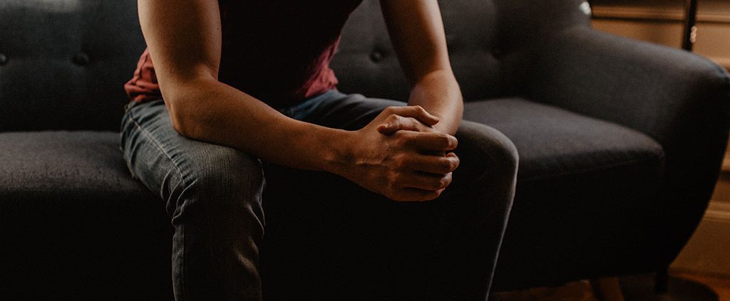 Man sitting with his hands clasped together