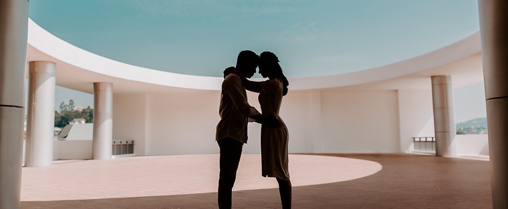 Couple holding one another in a courtyard