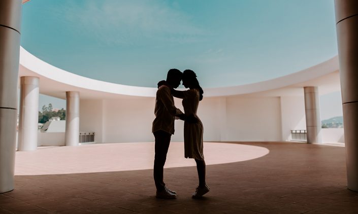 Couple holding one another in a courtyard