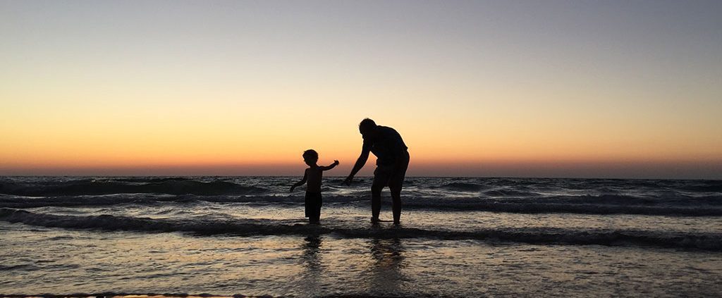 A father and his son playing in the water