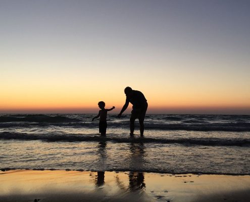 A father and his son playing in the water