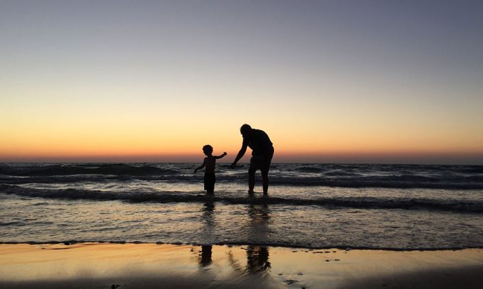 A father and his son playing in the water