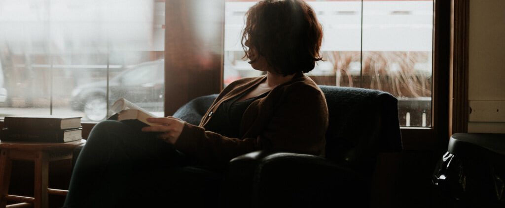 Woman sitting reading the bible