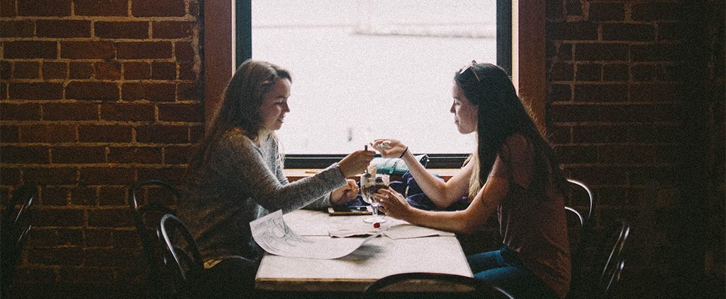 Two girls enjoying an ice cream sundae