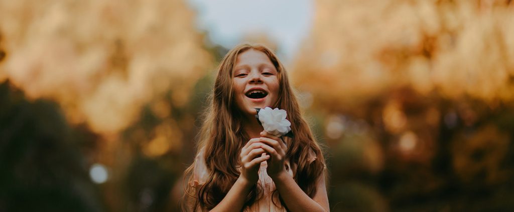 Girl holding a beautiful flower in her hands