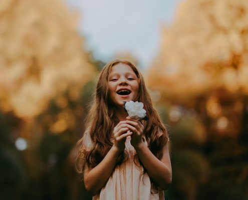 Girl holding a beautiful flower in her hands