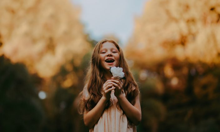 Girl holding a beautiful flower in her hands
