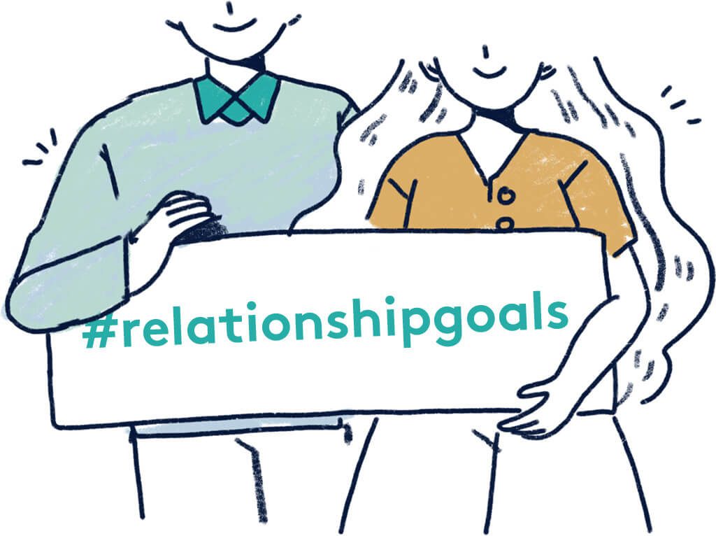 Relationship Goals Images- couple holding up relationship goals sign