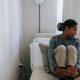 Woman sitting in bed sad and alone - is loneliness a sin